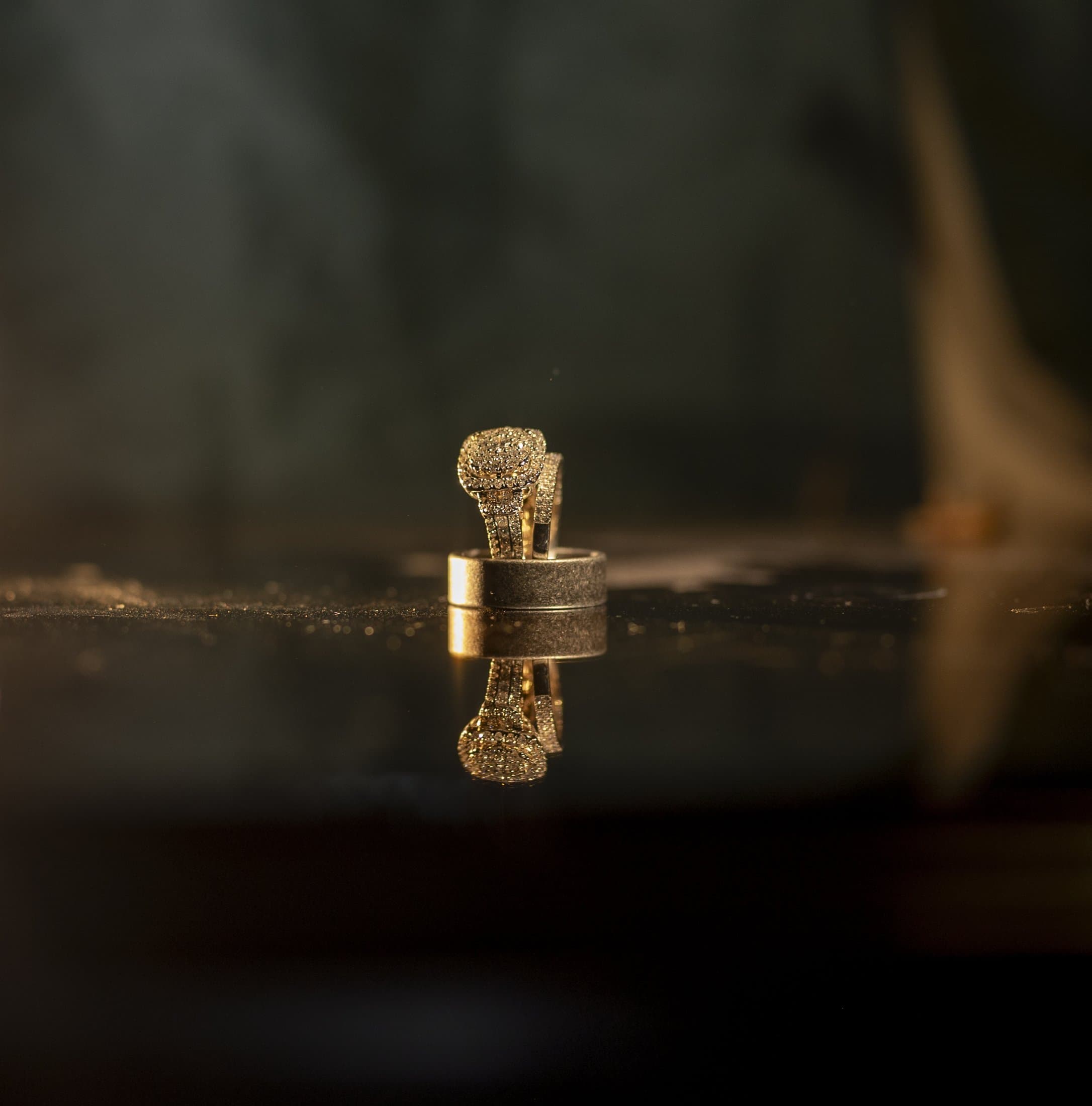 Wedding rings arranged together against a dark background